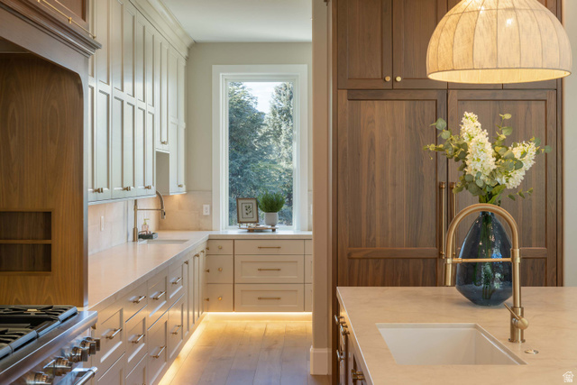 4292 Silver Sage Circle Alpine, UT 84004 - Photo 12 of 41 Contemporary kitchen featuring extensive cabinetry, under-cabinet lighting, a large window, and wood-finish flooring