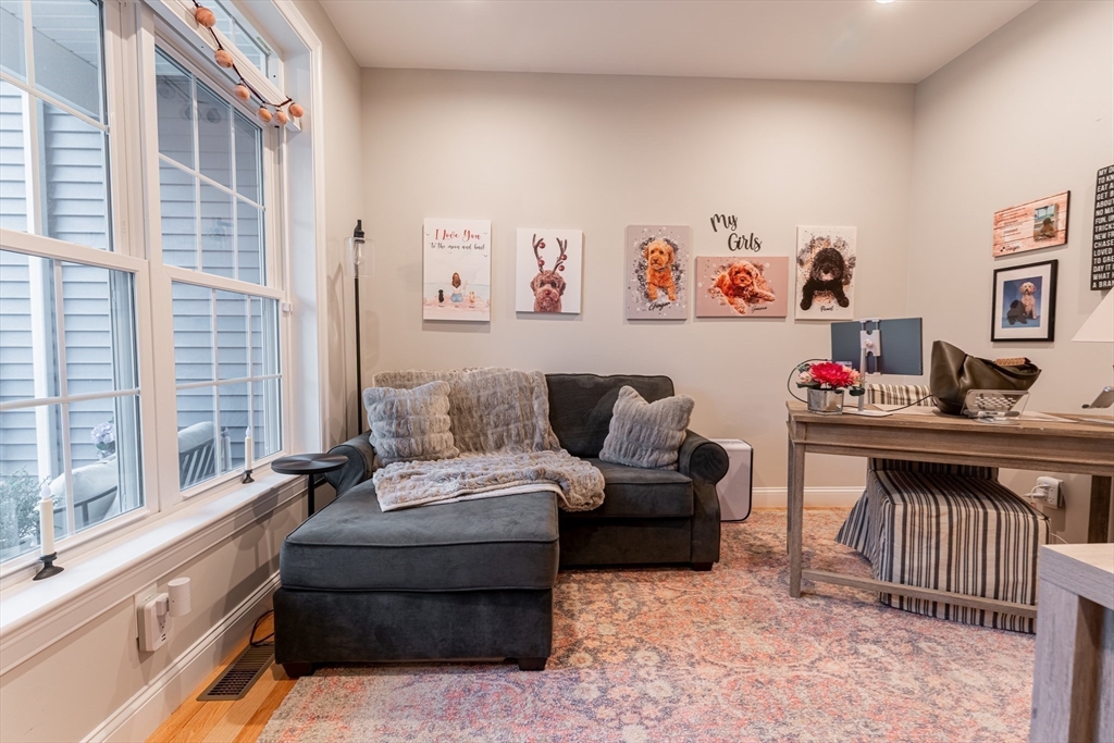 38 Cherry Street, Unit B Hudson, MA 01749 - Photo 17 of 33 a living room with furniture and a window