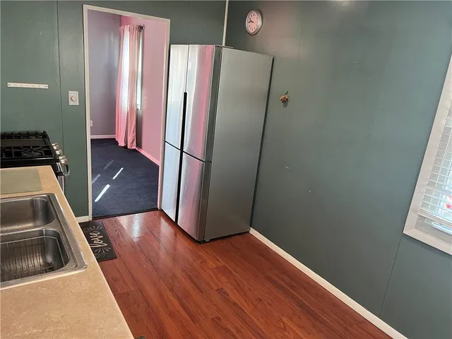 a view of a kitchen from a hallway