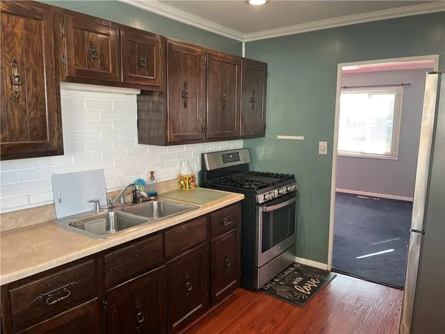 a kitchen with a sink and wooden cabinets