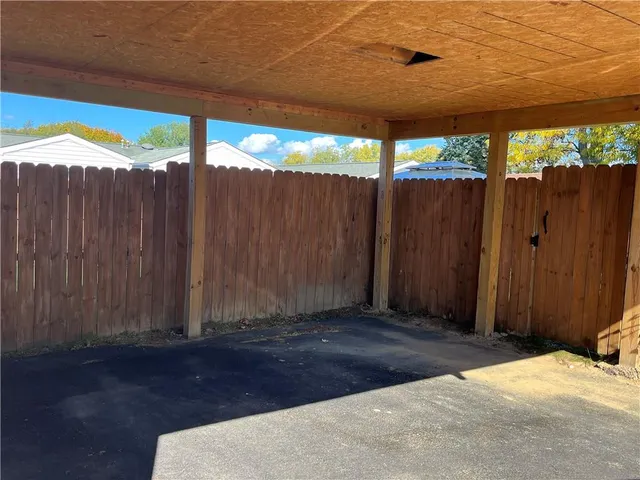 a view of a backyard with wooden fence