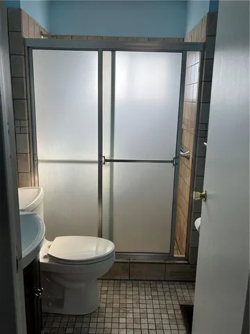 a bathroom with a toilet a sink and a shower