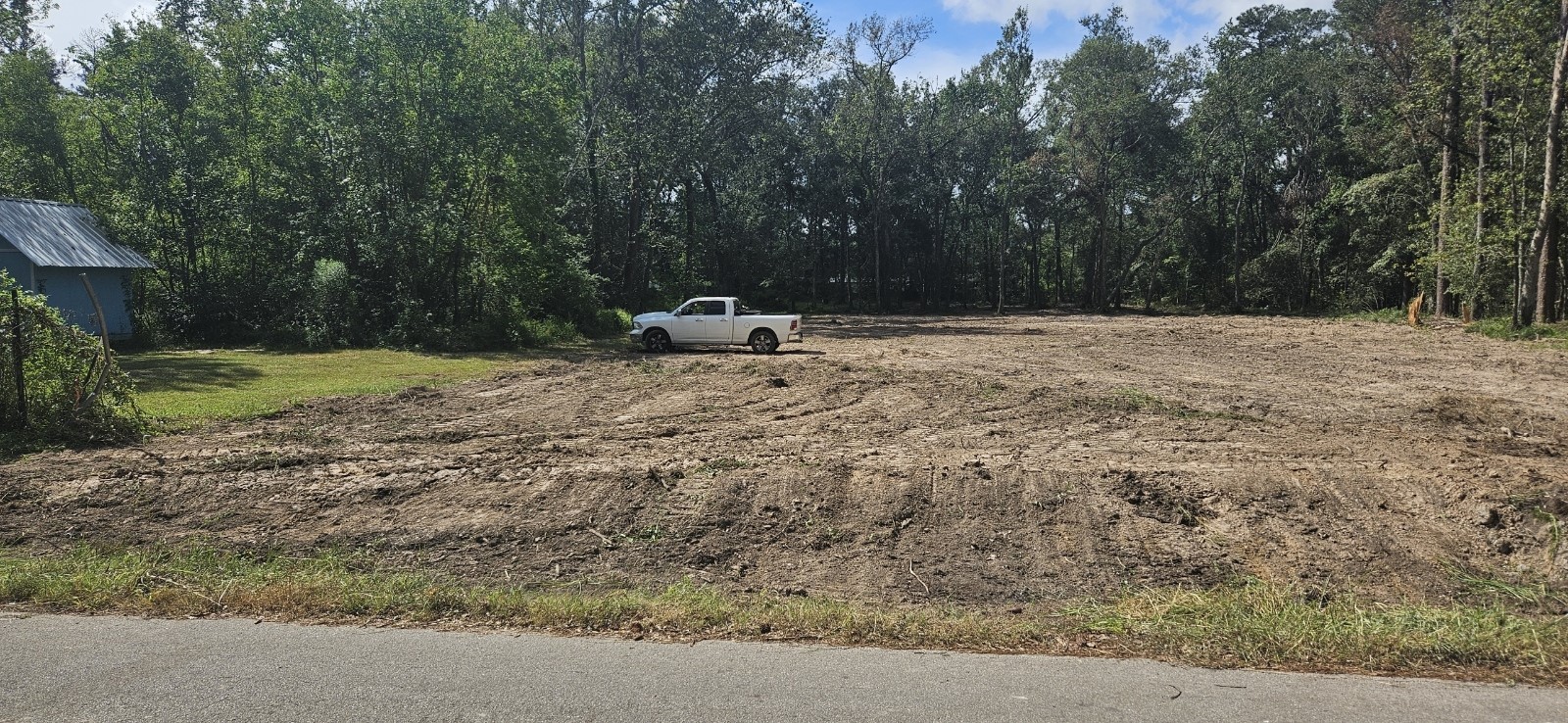 26994 Center Street Splendora, TX 77372 - Photo 2 of 3 a backyard of a house with trees and wooden fence