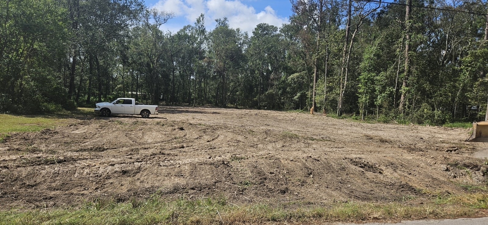26994 Center Street Splendora, TX 77372 - Photo 3 of 3 a wooden bench sitting in middle of a field