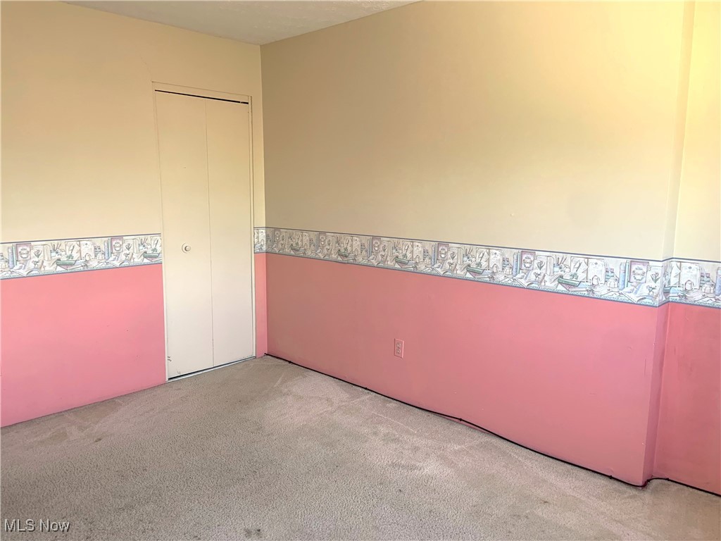 9956 Johnnycake Ridge Road, Unit D9 Painesville, OH 44077 - Photo 28 of 37 Unfurnished room featuring carpet flooring and a textured ceiling