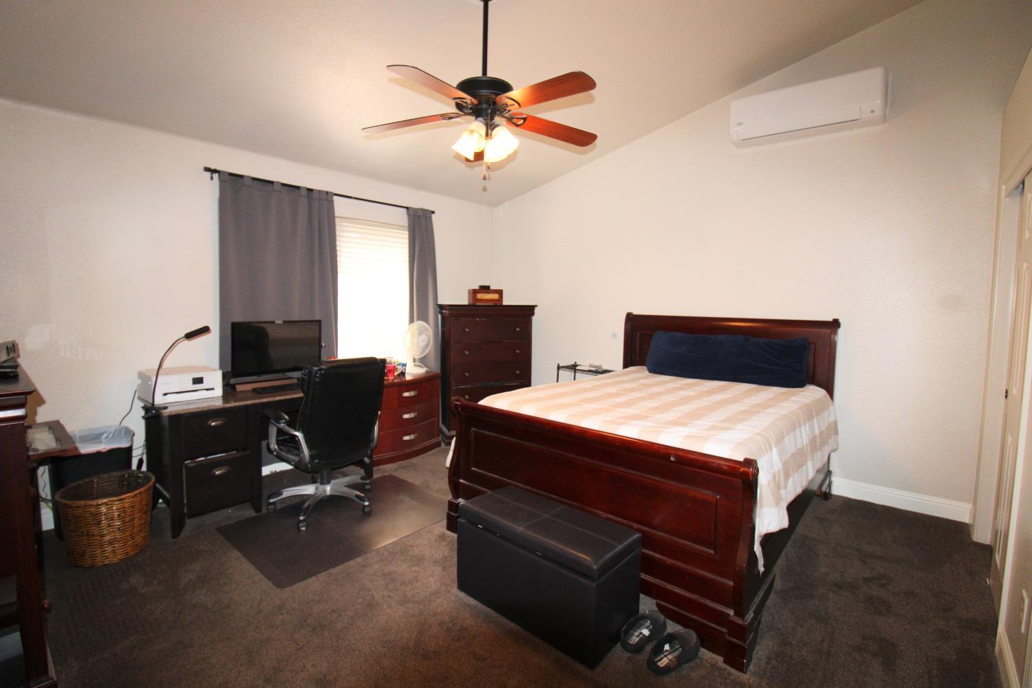 554 St Michelle Drive Madera, CA 93637 - Photo 15 of 19 a bedroom with a bed and a chandelier