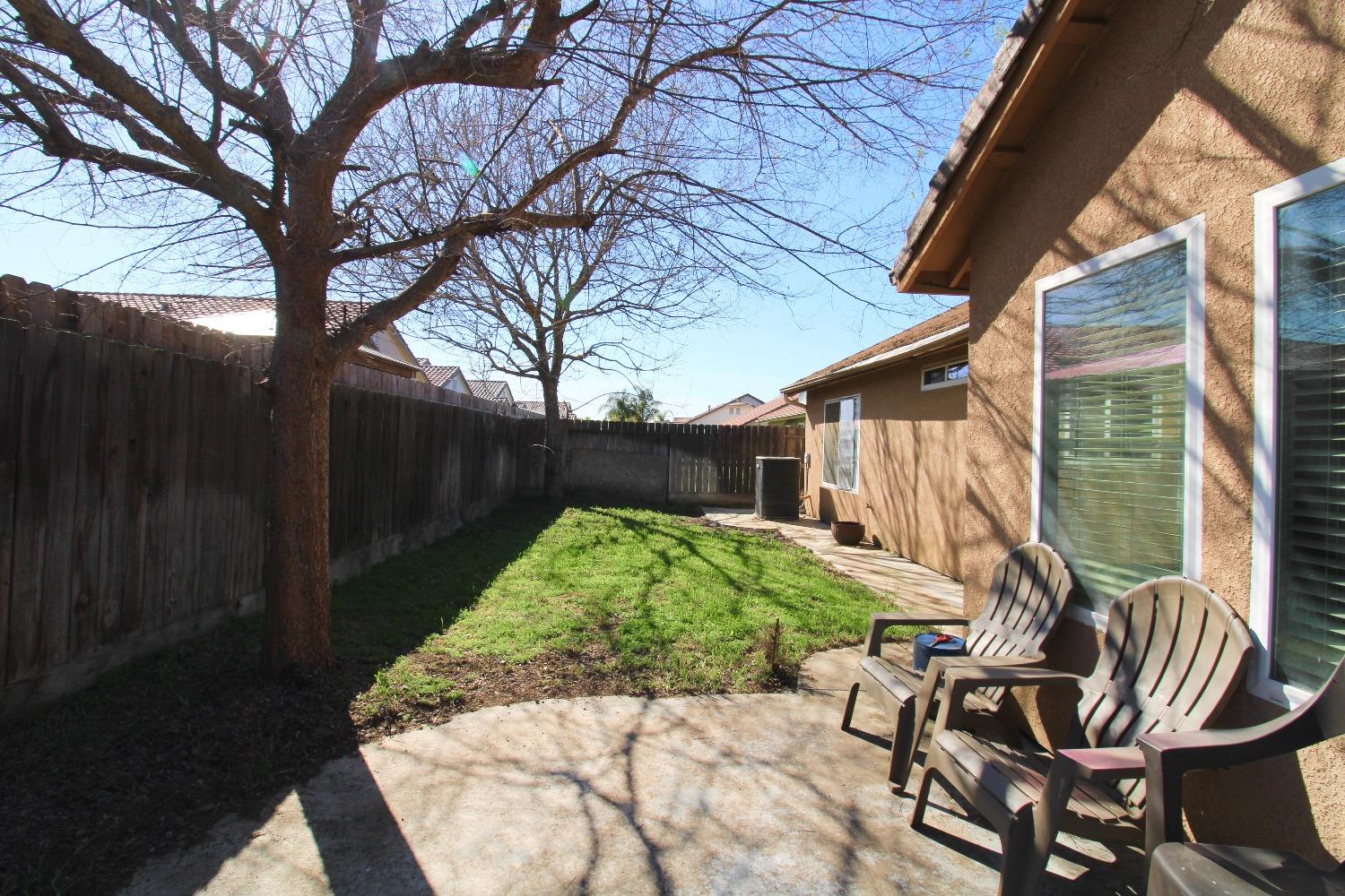 554 St Michelle Drive Madera, CA 93637 - Photo 19 of 19 a view of backyard with patio area and outdoor seating