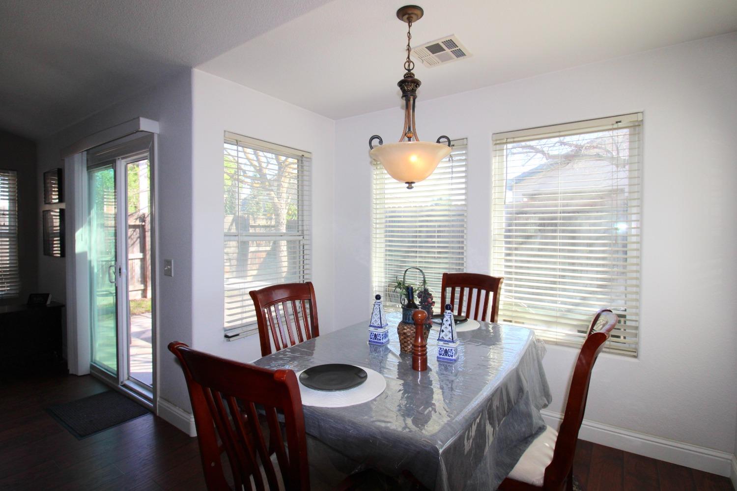 554 St Michelle Drive Madera, CA 93637 - Photo 8 of 19 a view of a dining room with furniture window and wooden floor