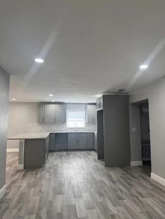 a view of kitchen and wooden floor