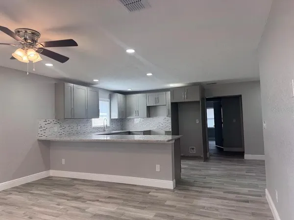 a view of kitchen with cabinets and wooden floor
