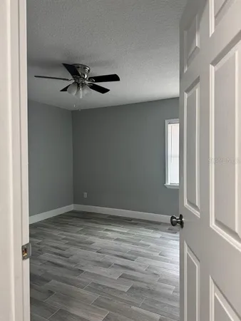 a view of a livingroom with a ceiling fan and window