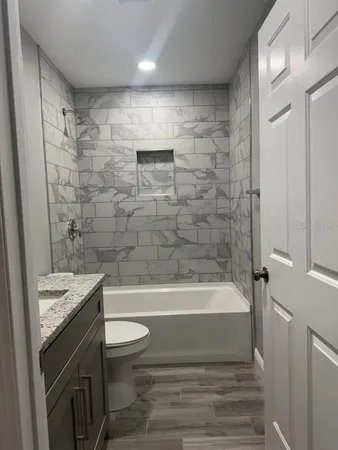 a bathroom with a sink a toilet and a bathtub