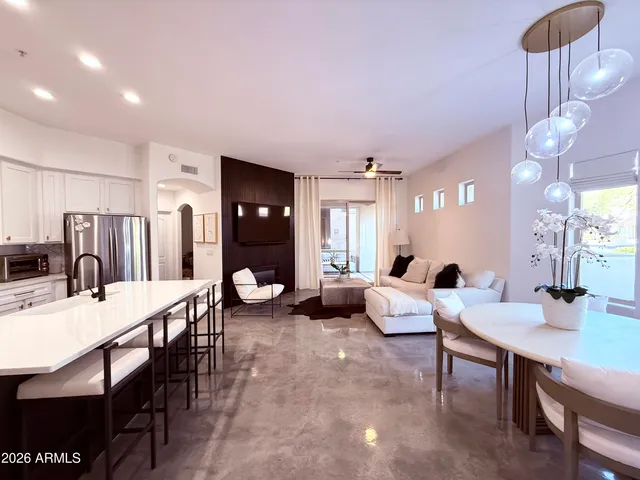 a large kitchen with a table and chairs