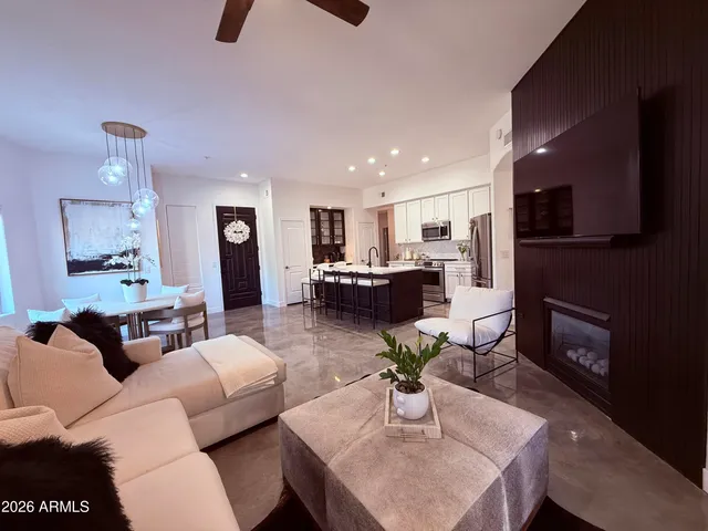a living room with furniture and a kitchen view