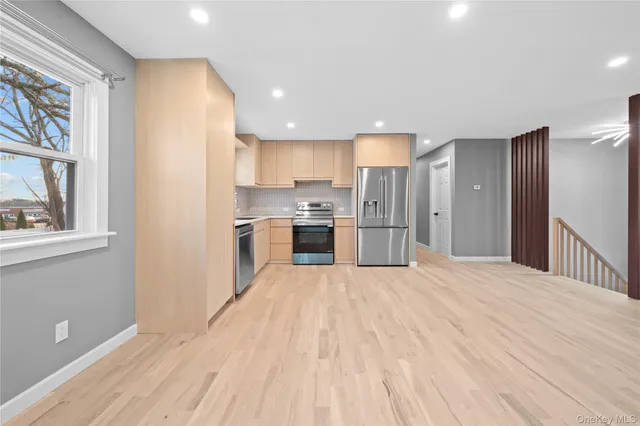 a view of a kitchen with a refrigerator an entryway and a kitchen view
