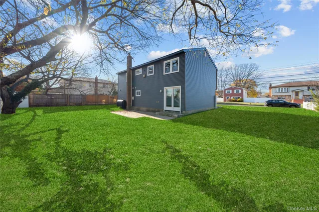 a view of front of a brick house with a yard