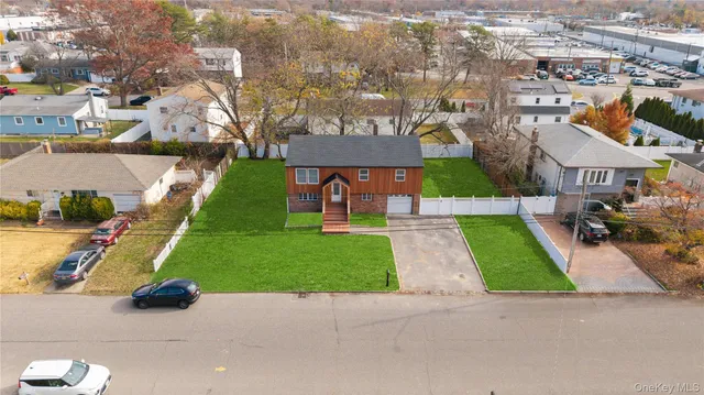 an aerial view of multiple houses with yard