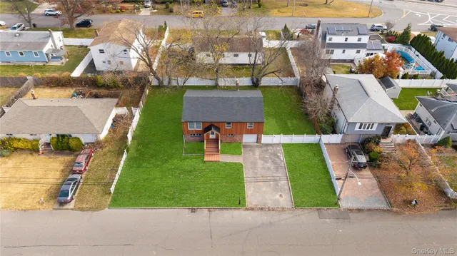 an aerial view of multiple houses with yard