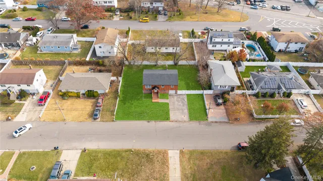 an aerial view of multiple houses with yard