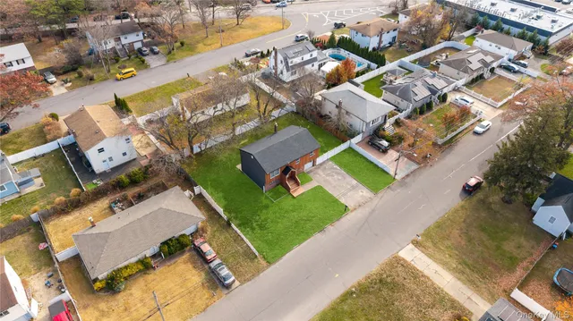 an aerial view of residential houses with outdoor space