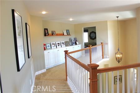 45344 St Tisbury Street Temecula, CA 92592 - Photo 13 of 28 a view of a hallway to a livingroom with furniture stairs and a couch