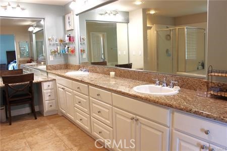 45344 St Tisbury Street Temecula, CA 92592 - Photo 16 of 28 a bathroom with double sink and a mirror