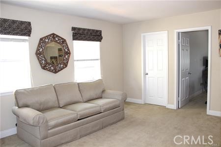 45344 St Tisbury Street Temecula, CA 92592 - Photo 19 of 28 a living room with furniture a couch and a window