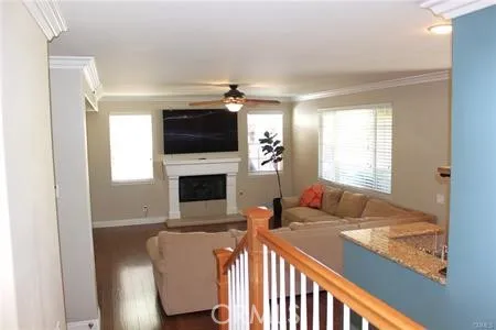 a living room with furniture a flat screen tv and a fireplace