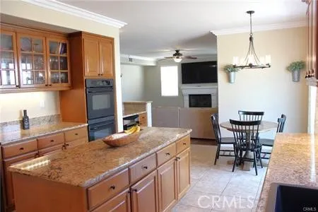 a kitchen with a table chairs and refrigerator