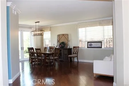 a dining room with furniture window and wooden floor