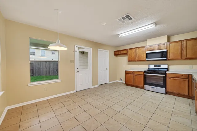 a kitchen with stainless steel appliances a sink and a stove top oven