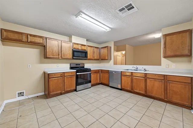 a kitchen with stainless steel appliances granite countertop a sink and cabinets
