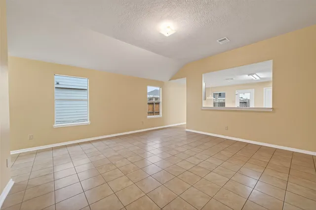 a view of an empty room with windows