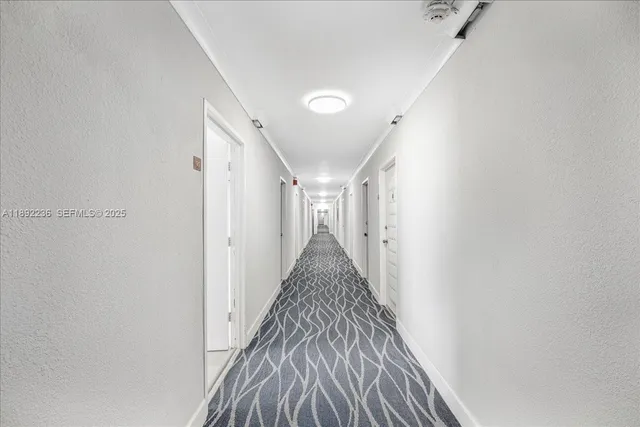 a view of a hallway with wooden floor and entryway
