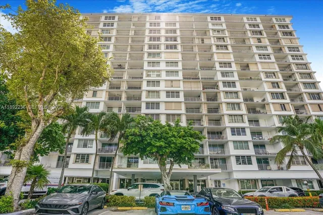 a front view of a building with a yard