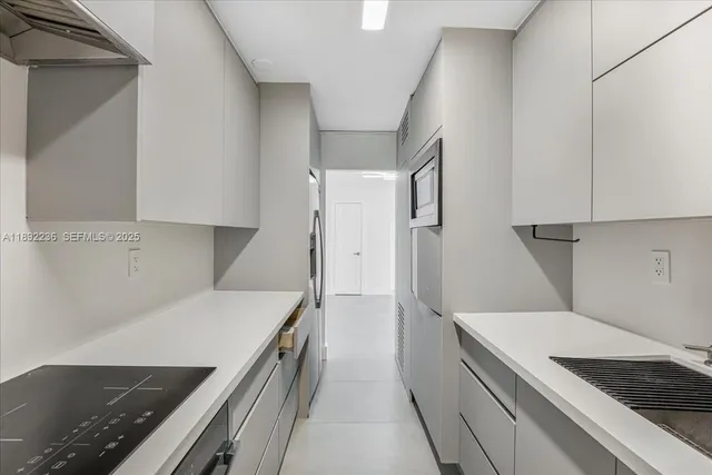 a kitchen with a stove and a refrigerator