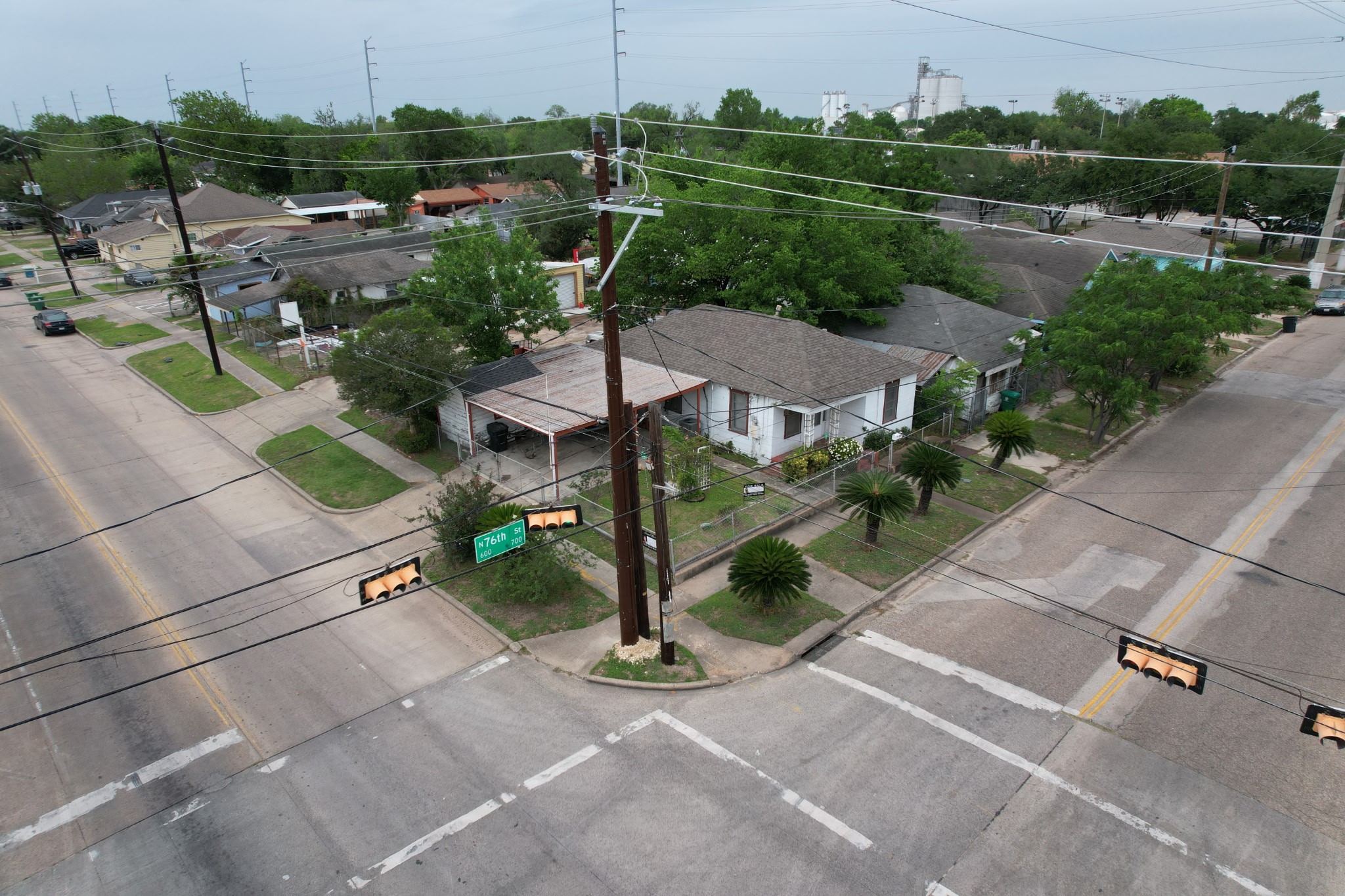 an aerial view of a house with a yard and lake view