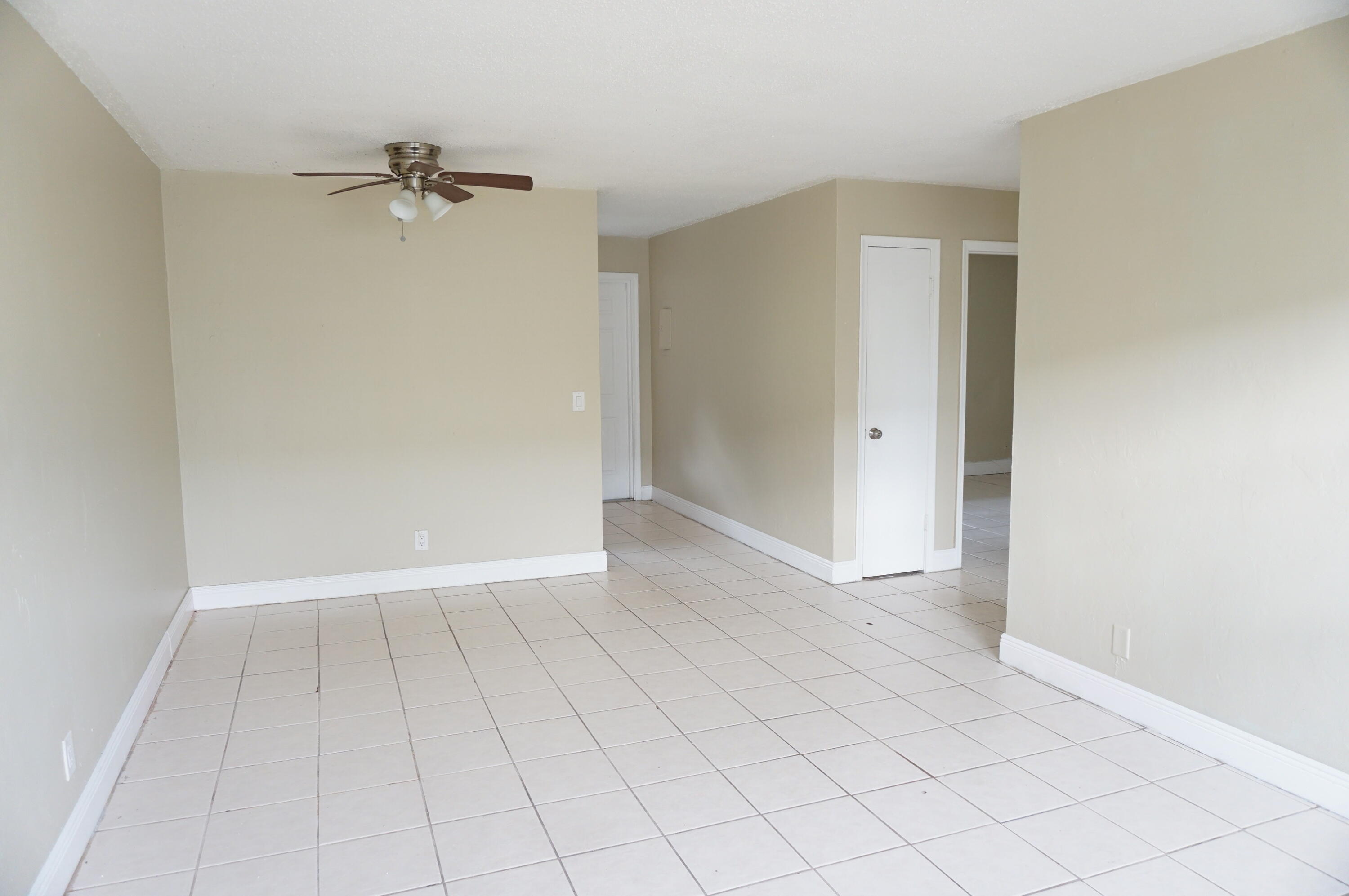 1601 West 37th Street, Unit 6 Riviera Beach, FL 33404 - Photo 2 of 6 a view of an empty room and chandelier fan