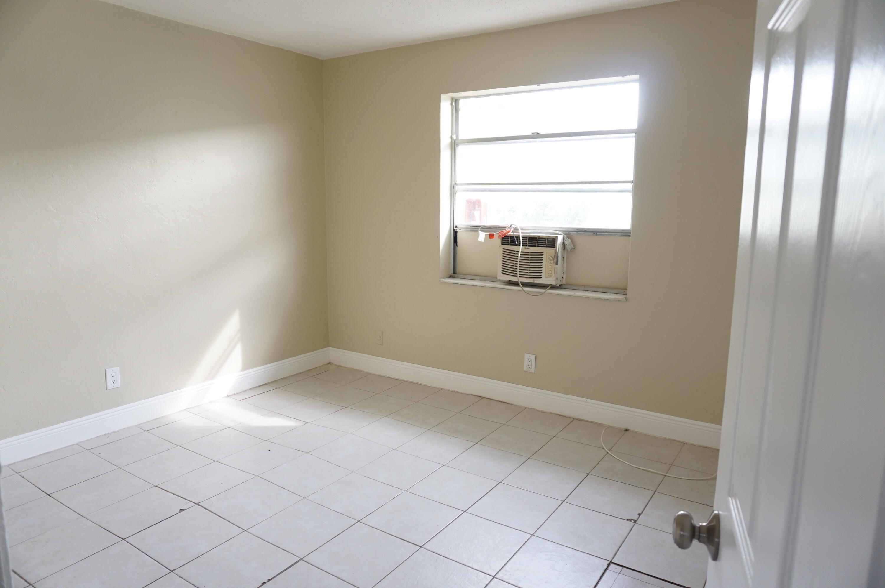 1601 West 37th Street, Unit 6 Riviera Beach, FL 33404 - Photo 4 of 6 an empty room with windows