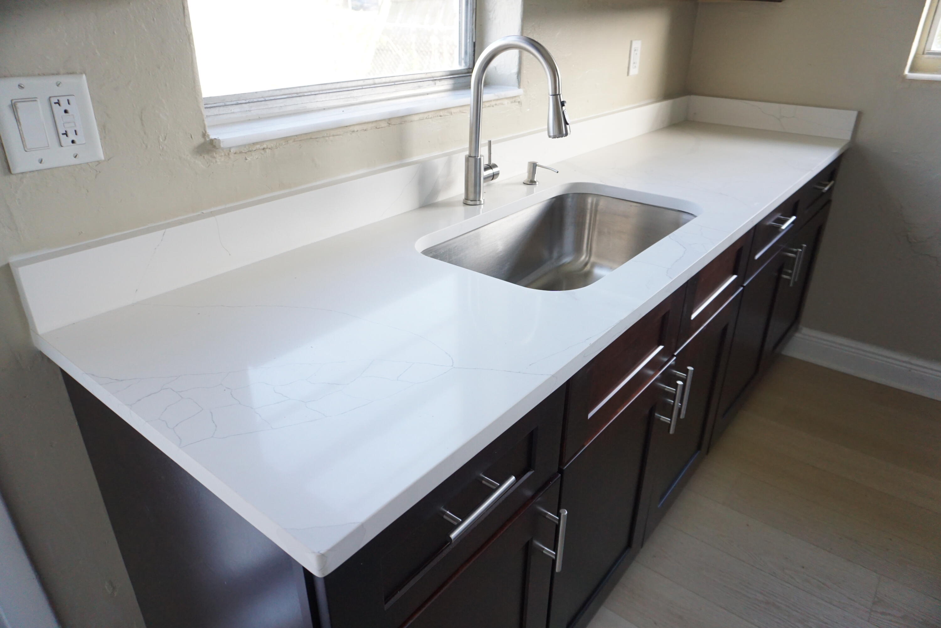 1601 West 37th Street, Unit 6 Riviera Beach, FL 33404 - Photo 4 of 12 a kitchen with kitchen island a sink and a stove
