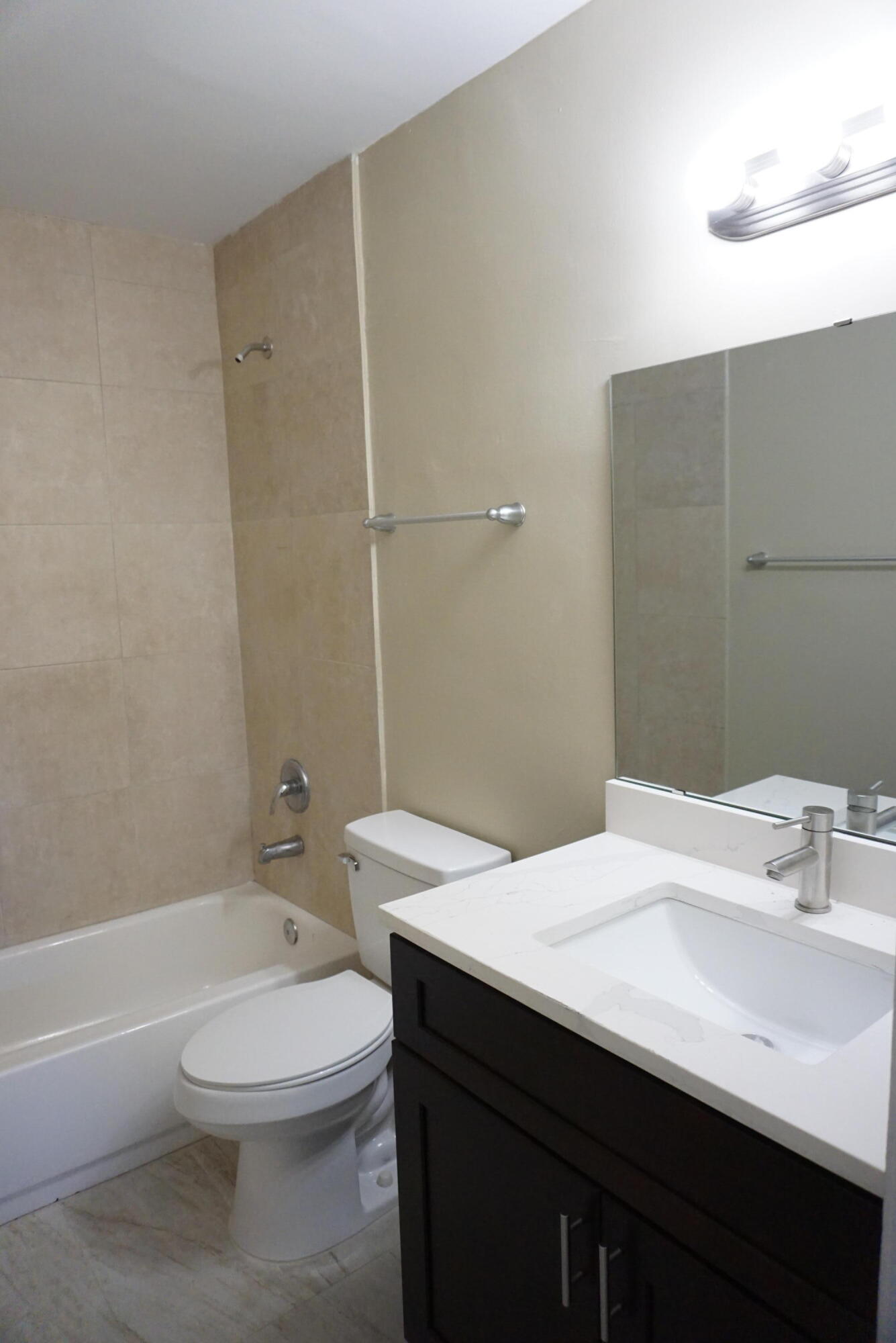 1601 West 37th Street, Unit 6 Riviera Beach, FL 33404 - Photo 7 of 12 a bathroom with a sink a toilet and shower