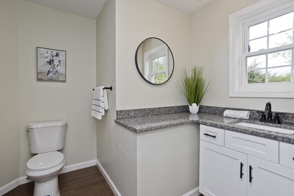 2089 Oak Street Three Rivers, MA 01080 - Photo 13 of 42 a bathroom with a granite countertop toilet sink and mirror