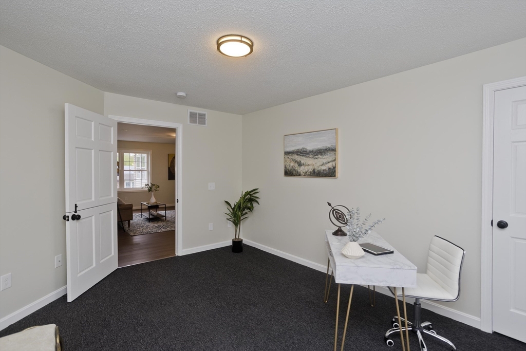 2089 Oak Street Three Rivers, MA 01080 - Photo 15 of 42 a view of a workspace with furniture and wooden floor