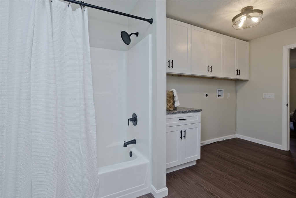2089 Oak Street Three Rivers, MA 01080 - Photo 19 of 42 a kitchen with white cabinets and wooden floor