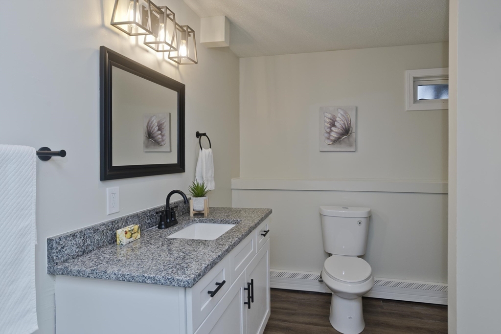 2089 Oak Street Three Rivers, MA 01080 - Photo 33 of 42 a bathroom with a granite countertop toilet sink and mirror