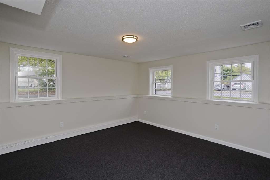 2089 Oak Street Three Rivers, MA 01080 - Photo 37 of 42 a view of an empty room with wooden floor and a window