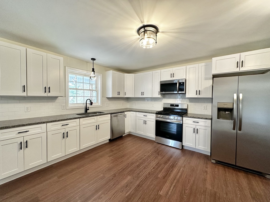 2089 Oak Street Three Rivers, MA 01080 - Photo 5 of 42 a large kitchen with cabinets wooden floor and stainless steel appliances