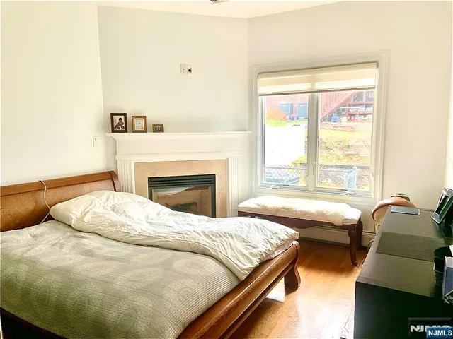 a view of a room with wooden floor and a window