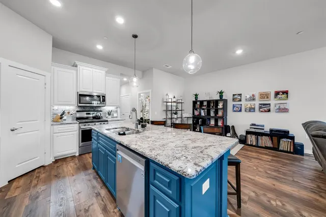 a large kitchen with cabinets table and chairs
