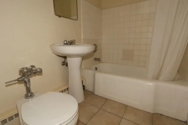 a bathroom with a sink a toilet and bathtub